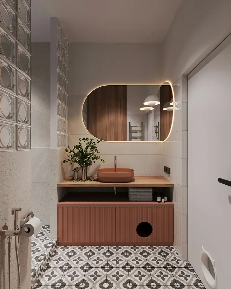 Kiremit rengi lavabo dolabı, kemerli ayna ve desenli karo zeminli banyo